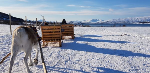 Scenic view of snow covered field against sky