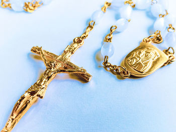 High angle view of rosary beads on white background