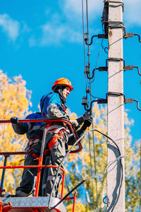 Low angle view of man standing against clear sky