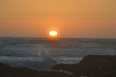 Scenic view of sea at sunset