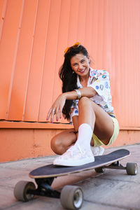 Portrait of smiling young woman sitting outdoors