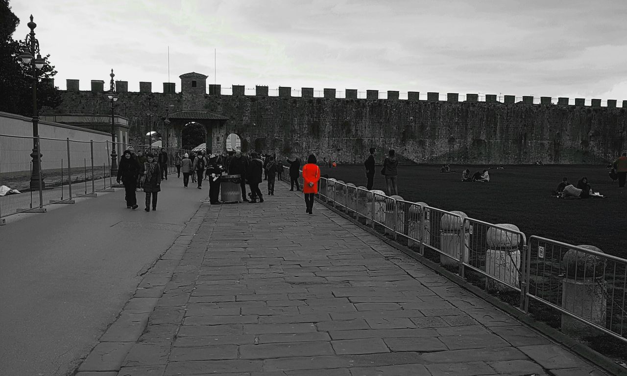 PEOPLE IN ROW OF BRIDGE AGAINST SKY