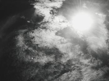 Low angle view of sun shining over water