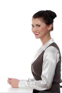 Portrait of a smiling young woman over white background