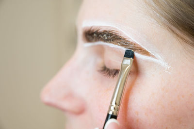 Close-up of woman holding thermometer