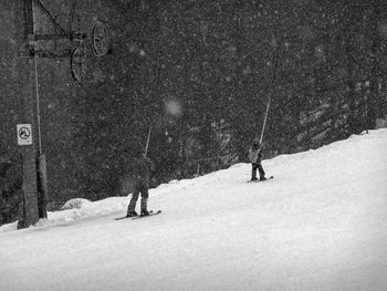 People skiing on snow covered slope