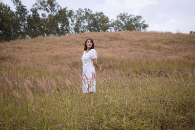 Young woman standing on field