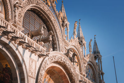 Low angle view of historic building against clear blue sky