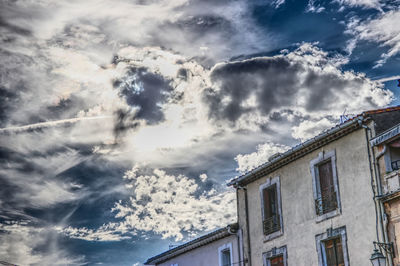 Low angle view of building against cloudy sky