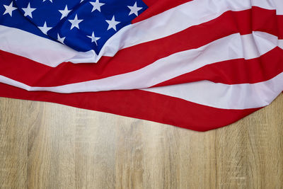 Close-up of american flag on wooden floor