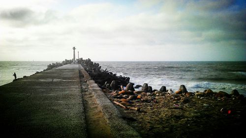 Scenic view of sea against cloudy sky