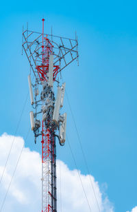 Telecommunication tower with blue sky and white clouds background. antenna on blue sky. 