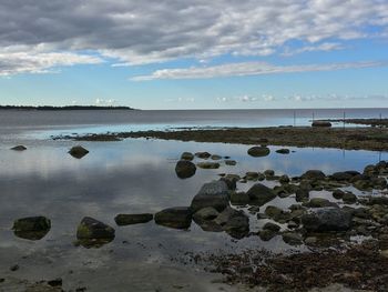 Scenic view of sea against cloudy sky