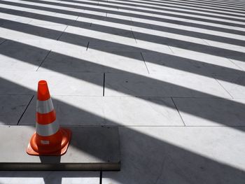 High angle view of traffic cone on footpath during sunny day