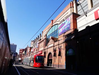 Cable car by building on street in city