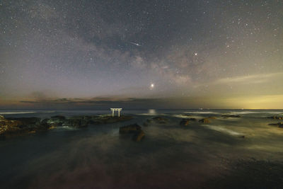 Scenic view of sea against sky at night