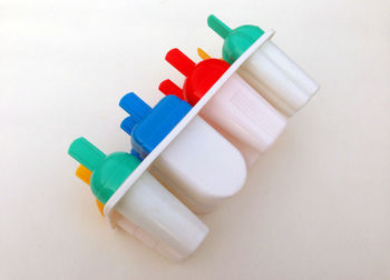 High angle view of multi colored pencils on white background