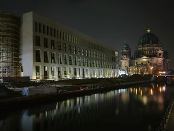 Reflection of illuminated buildings in city at night