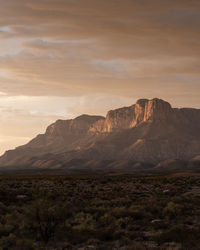 Scenic view of rocky mountains against sky during sunset