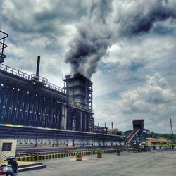 Low angle view of building against cloudy sky