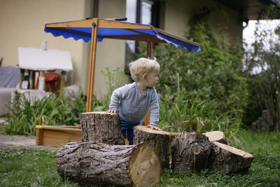 Portrait of smiling young woman standing in yard