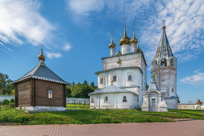 Church by building against sky