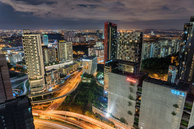 High angle view of illuminated cityscape against sky at night