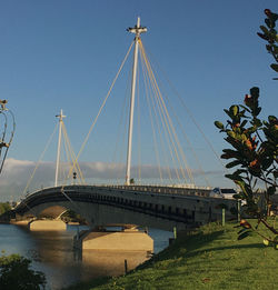 Bridge over river against clear blue sky