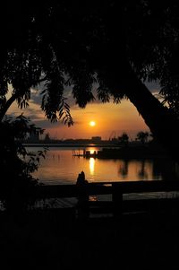 Scenic view of lake against orange sky