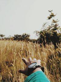 Man standing on field against clear sky