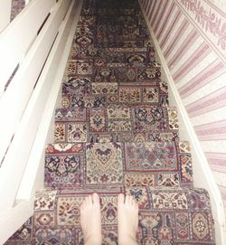 Low section of woman standing on tiled floor