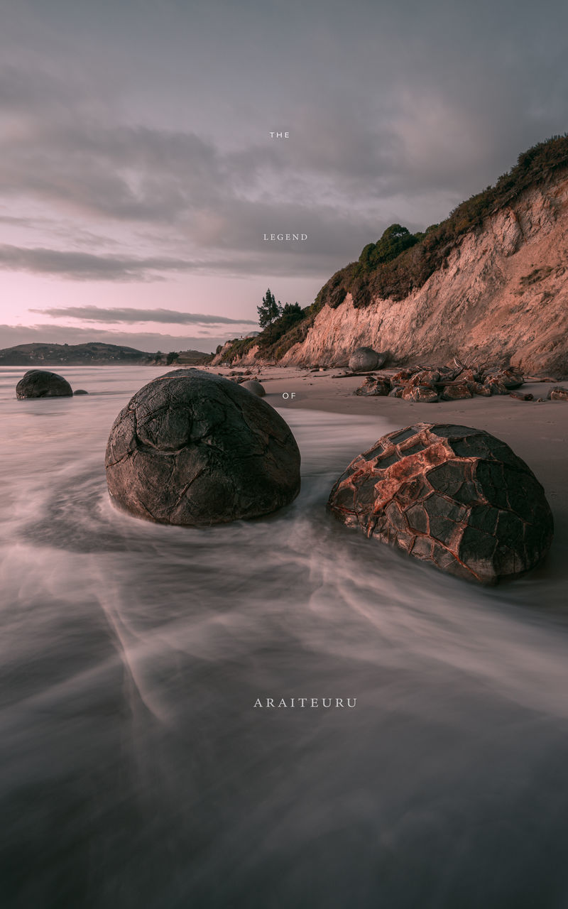 SCENIC VIEW OF ROCKS ON BEACH AGAINST SKY