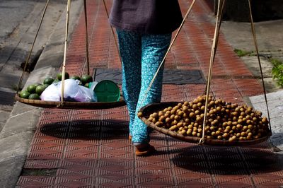 Low section of woman standing on food