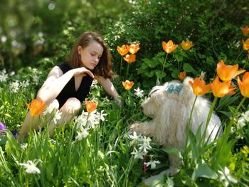 Cute girl with flowers and plants