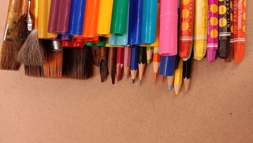 High angle view of multi colored pencils in row