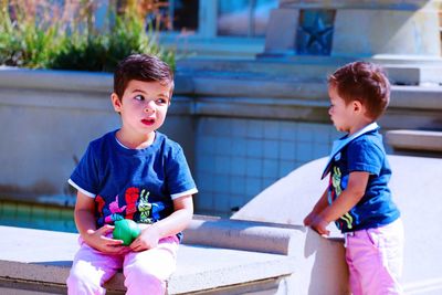 Cute boy sitting outdoors