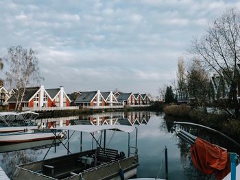 Boats moored in lake against sky