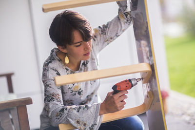 Upcycling young woman on a terrace