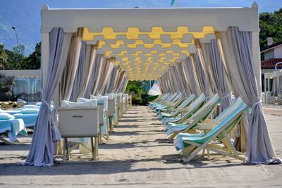 Empty deck chairs arranged at beach