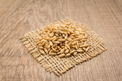 Wheat on jute over wooden table