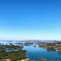 High angle view of bay against clear blue sky