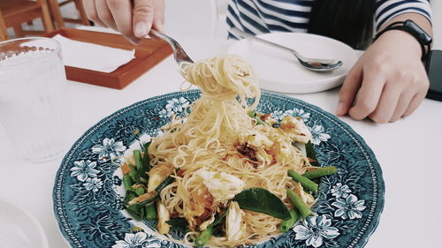 Midsection of person in plate on table