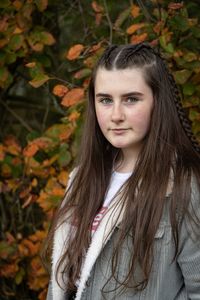 Portrait of young woman with autumn leaves