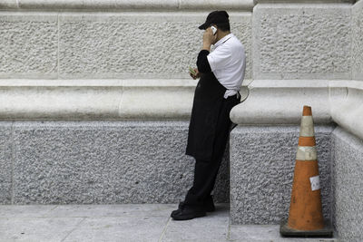 Midsection of man using mobile phone