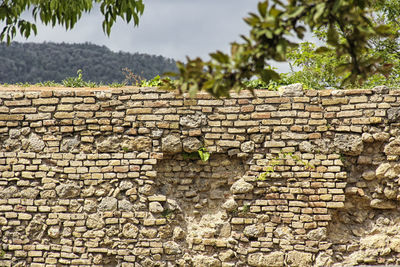 Close-up of brick wall against sky