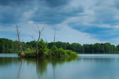 Scenic view of lake against cloudy sky