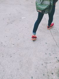 Low section of woman standing on tiled floor