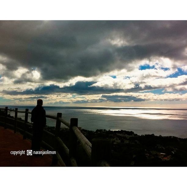 sky, transfer print, water, cloud - sky, sea, auto post production filter, lifestyles, men, standing, silhouette, leisure activity, cloudy, railing, sitting, horizon over water, rear view, looking at view, cloud