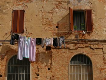 Low angle view of clothes drying outside house