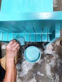 High angle view of man holding glass with water